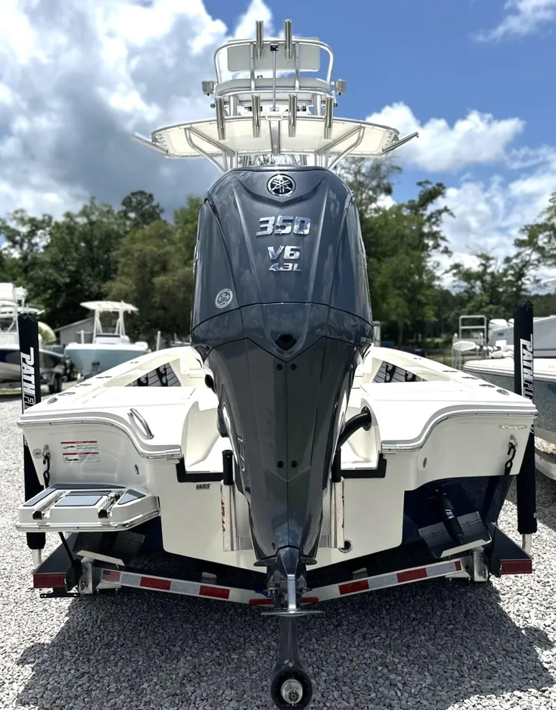 Slide: The Image of 2025 Pathfinder 2500 Hybrid boat with 350 V6 engine on trailer, parked outdoors. - 6