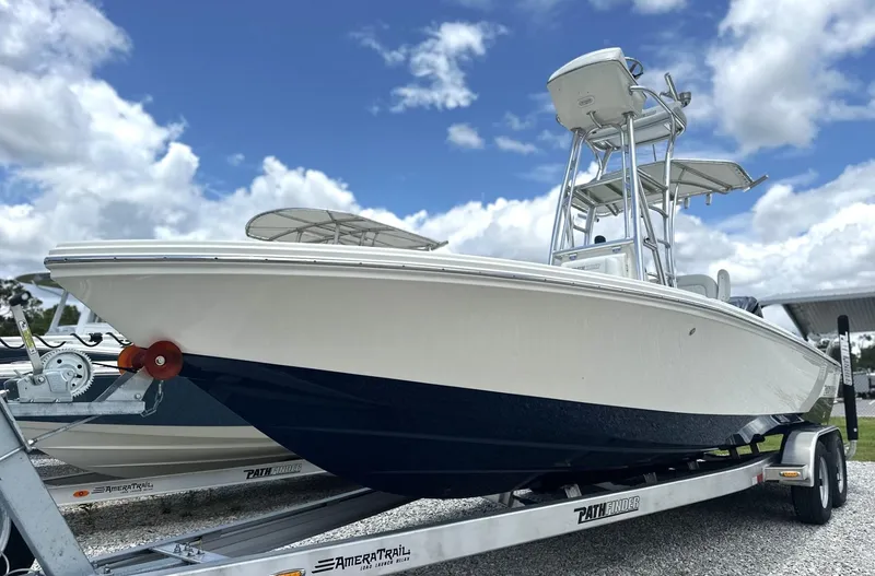Slide: The Image of 2025 Pathfinder 2500 Hybrid boat on trailer under blue sky. - 8