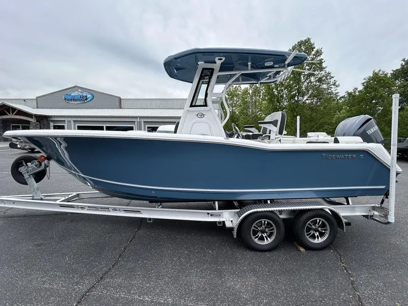 The Image of 2025 Tidewater 232 LXF boat on trailer, parked outdoors near dealership. - 1