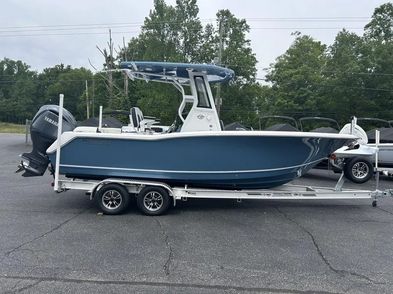Slide: The Image of 2025 Tidewater 232 LXF boat on trailer, blue hull, parked outdoors. - 3