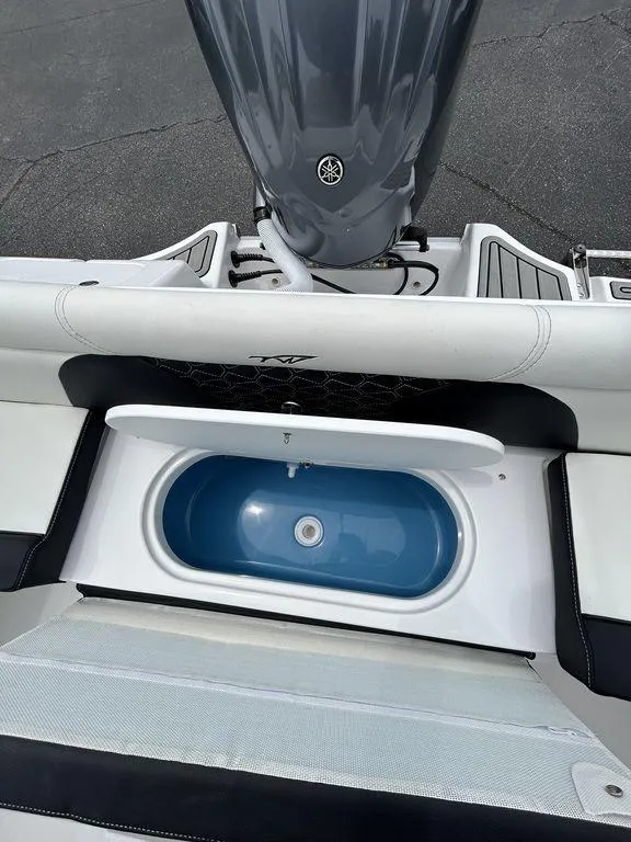 Slide: The Image of 2025 Tidewater 232 LXF boat with open storage compartment and Yamaha engine. - 8