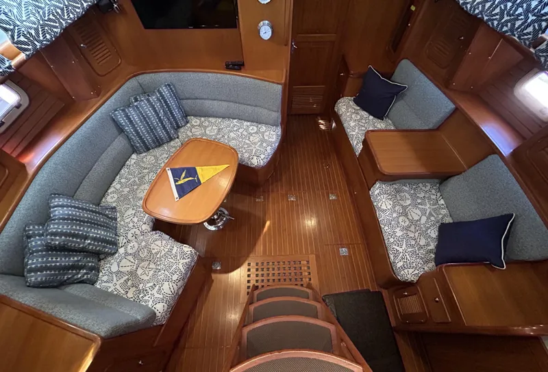 Slide: The Image of Luxurious interior of a 2004 Passport 470 yacht with elegant seating and wooden finishes. - 13