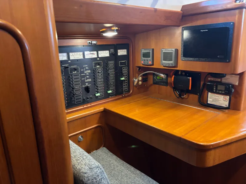 Slide: The Image of Navigation station of a 2004 Passport 470 yacht with control panels and instruments. - 17