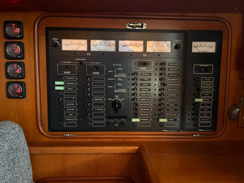 Slide: The Image of Electrical control panel on a 2004 Passport 470 yacht, featuring gauges and switches. - 18