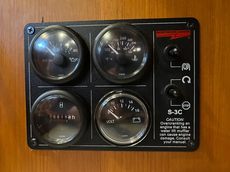 Slide: The Image of Control panel with gauges and caution label on a 2004 Passport 470. - 19