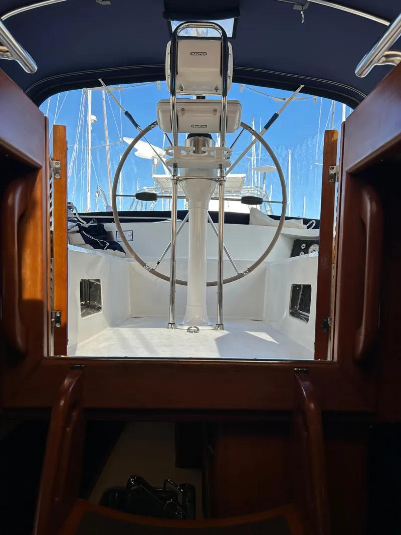 Slide: The Image of Interior view of 2004 Passport 470 sailboat cockpit with steering wheel. - 27