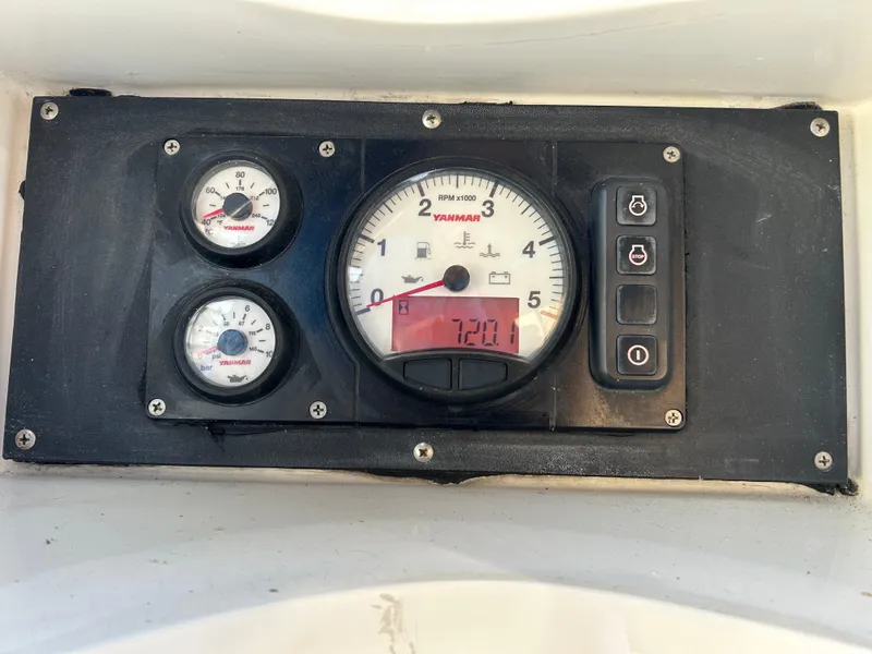 Slide: The Image of Control panel of a 2004 Passport 470 boat with Yanmar gauges. - 28