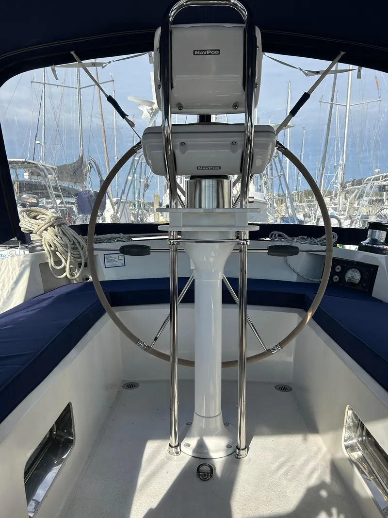 Slide: The Image of Cockpit of 2004 Passport 470 sailboat with steering wheel and navigation equipment. - 32