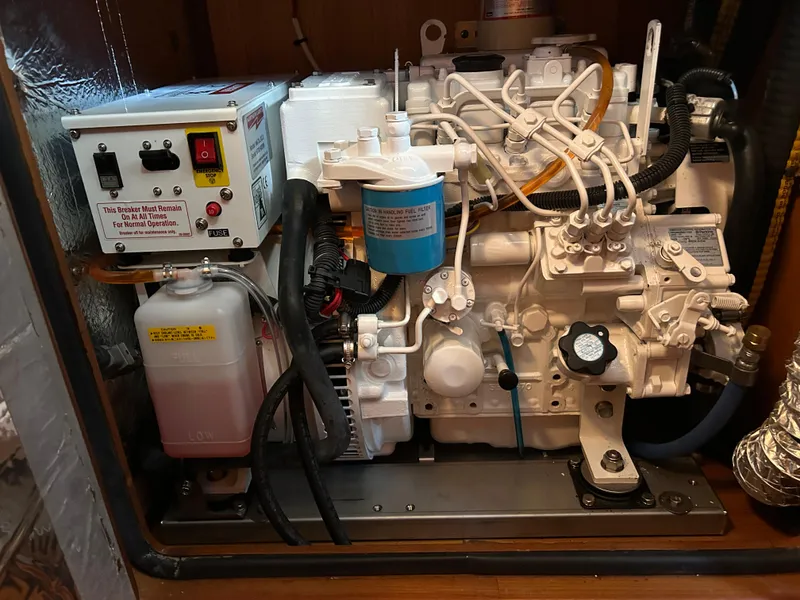 Slide: The Image of Engine compartment of a 2004 Passport 470, featuring mechanical components and control panel. - 33