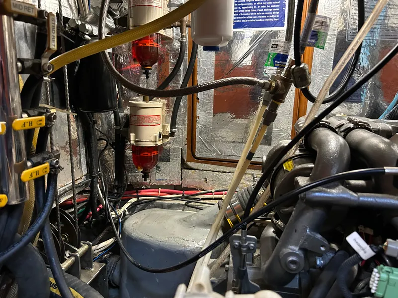 Slide: The Image of Engine room of a 2004 Passport 470 yacht, showcasing complex machinery and wiring. - 34