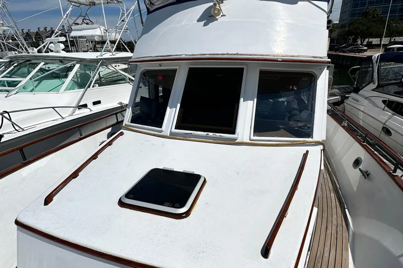 Slide: The Image of 1980 Island Gypsy Flush Aft Deck Trawler-Motor Yacht docked at marina. - 11