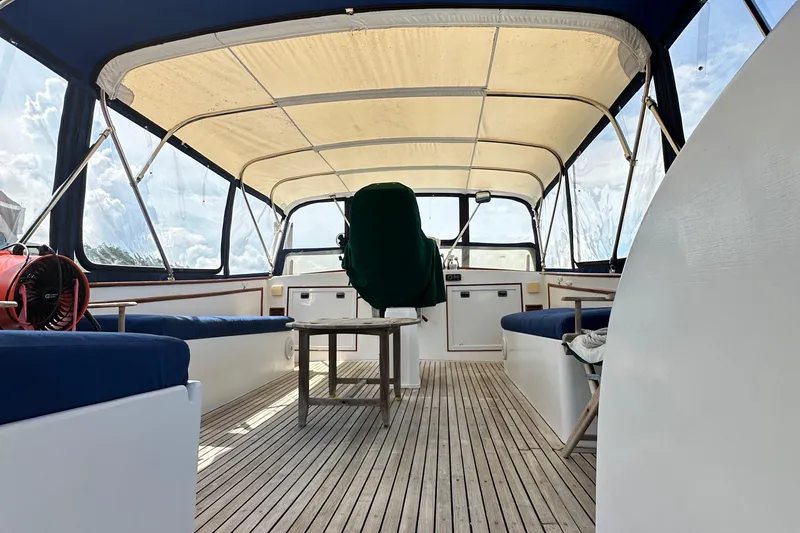 Slide: The Image of 1980 Island Gypsy Flush Aft Deck Trawler-Motor Yacht interior with canopy and seating. - 19