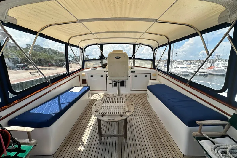 Slide: The Image of 1980 Island Gypsy Flush Aft Deck Trawler-Motor Yacht interior with seating and helm. - 25