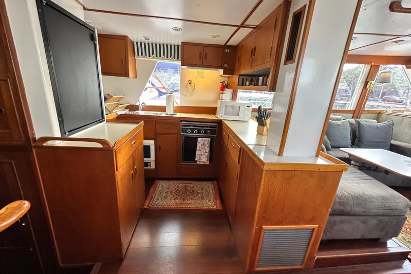 Slide: The Image of Interior of 1980 Island Gypsy Flush Aft Deck Trawler-Motor Yacht with cozy kitchen and seating area. - 32