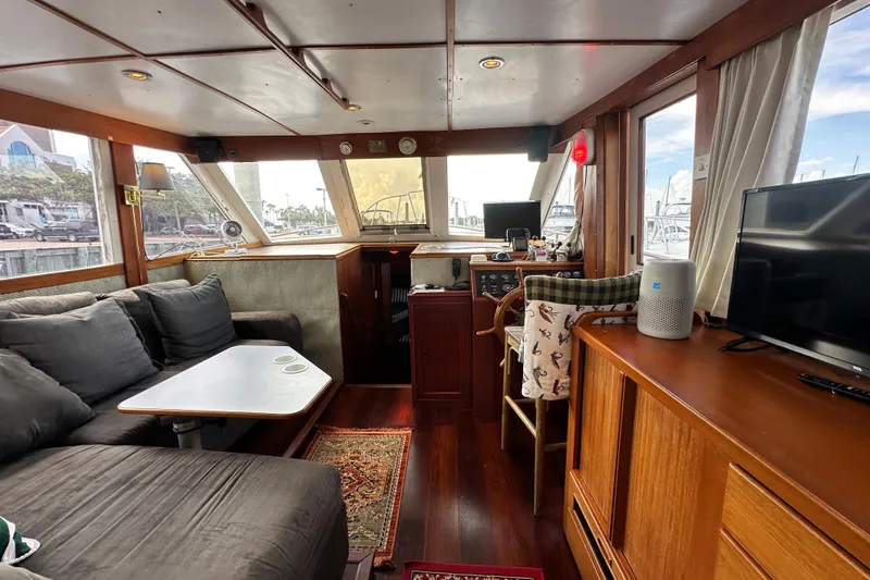 Slide: The Image of Interior of 1980 Island Gypsy Flush Aft Deck Trawler-Motor Yacht with cozy seating and navigation area. - 33