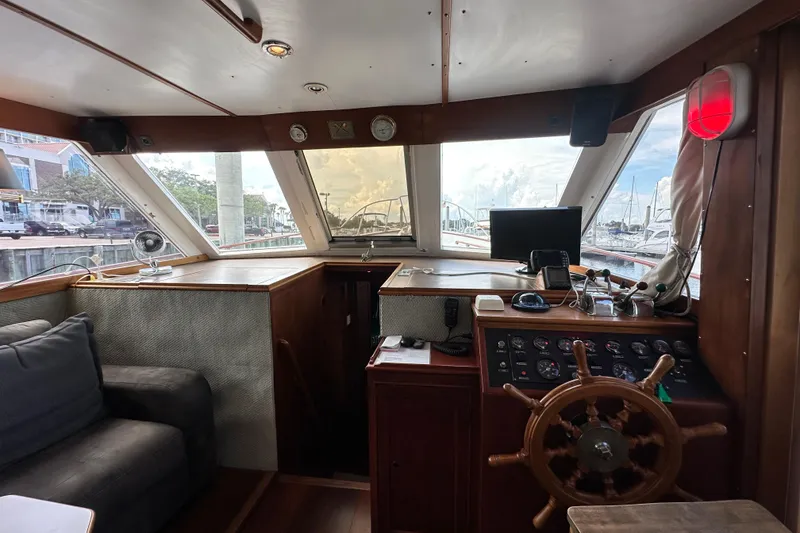 Slide: The Image of Interior of 1980 Island Gypsy Flush Aft Deck Trawler-Motor Yacht with helm and seating area. - 34