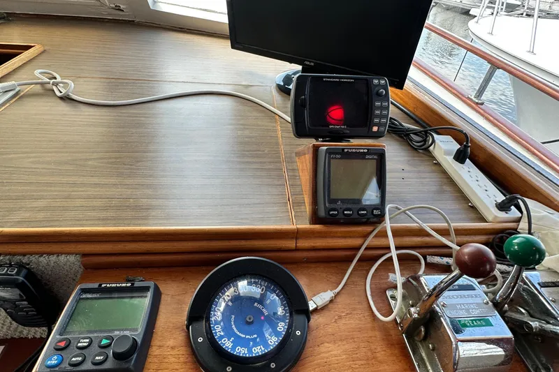 Slide: The Image of Control panel of 1980 Island Gypsy Flush Aft Deck Trawler-Motor Yacht with navigation instruments. - 35
