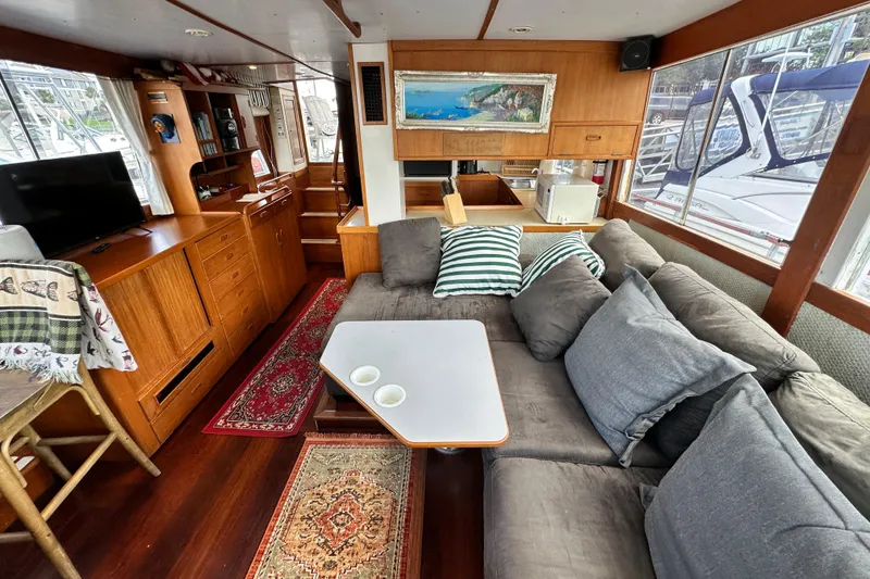 Slide: The Image of 1980 Island Gypsy Flush Aft Deck Trawler-Motor Yacht interior with cozy seating and nautical decor. - 38