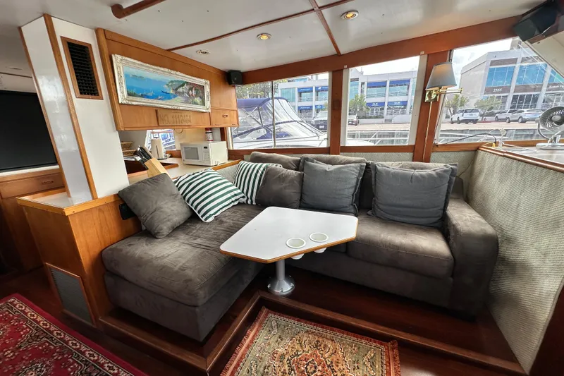 Slide: The Image of Interior of 1980 Island Gypsy Flush Aft Deck Trawler-Motor Yacht with cozy seating area. - 40