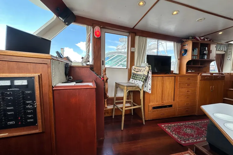 Slide: The Image of Interior of 1980 Island Gypsy Flush Aft Deck Trawler-Motor Yacht with wooden cabinetry and seating. - 41