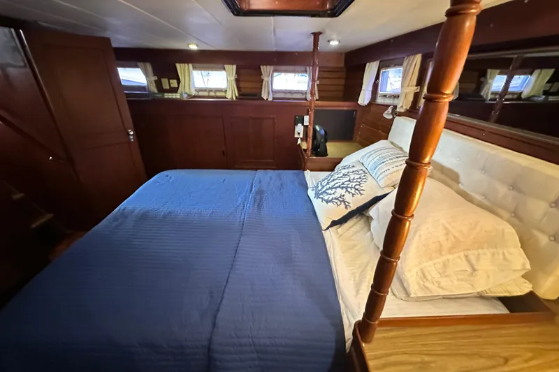 Slide: The Image of Cozy bedroom in 1980 Island Gypsy Flush Aft Deck Trawler-Motor Yacht with blue bedding. - 46