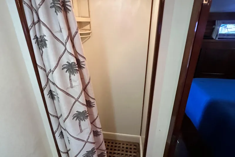 Slide: The Image of 1980 Island Gypsy yacht shower area with palm tree curtain and wooden floor. - 50