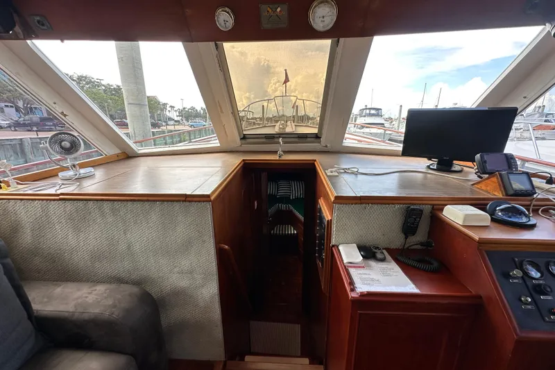 Slide: The Image of 1980 Island Gypsy Flush Aft Deck Trawler-Motor Yacht interior with navigation equipment and seating. - 55