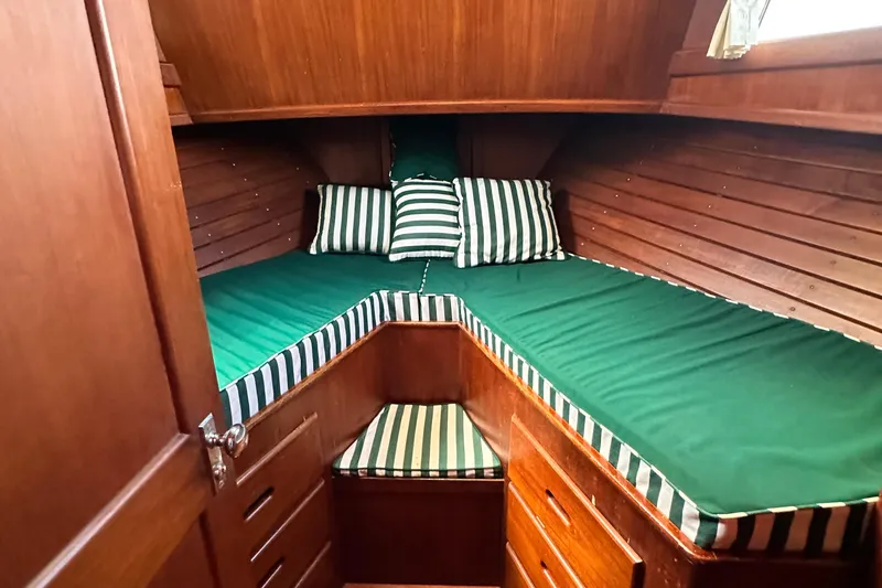 Slide: The Image of Cozy cabin interior of 1980 Island Gypsy Flush Aft Deck Trawler-Motor Yacht with green-striped bedding. - 59