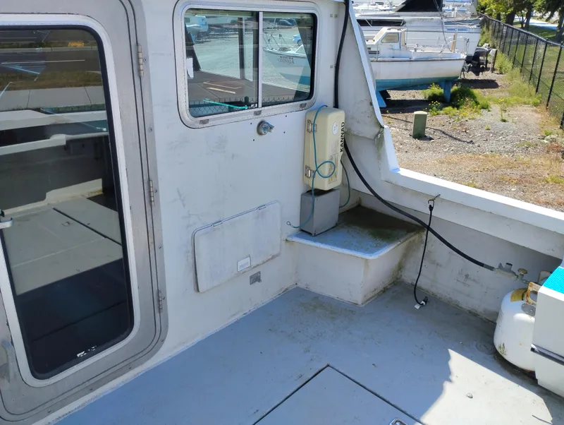 Slide: The Image of 1996 Martin Trunk Cabin boat interior with door, window, and docked surroundings. - 11