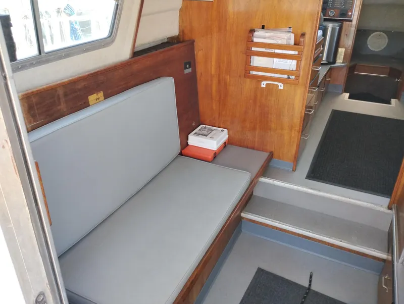Slide: The Image of Interior of a 1996 Martin Trunk Cabin boat with seating and wooden paneling. - 13