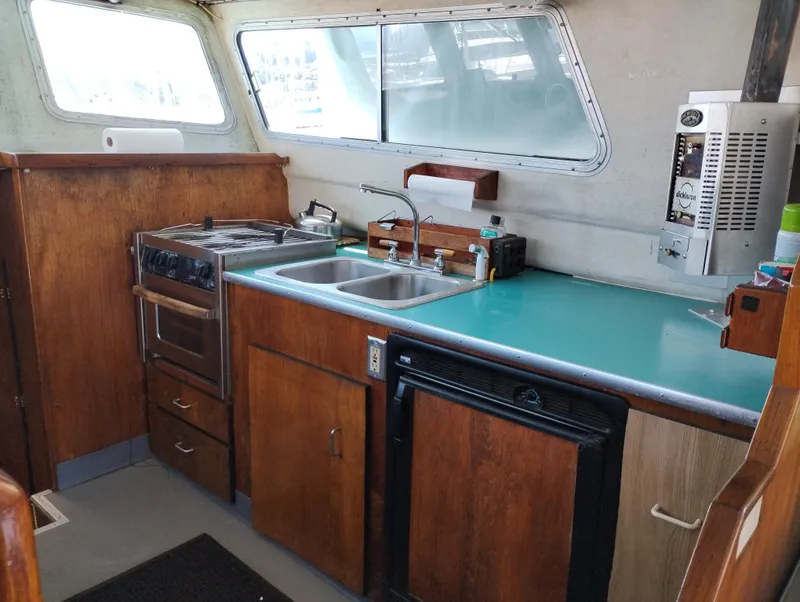 Slide: The Image of 1996 Martin Trunk Cabin kitchen with stove, sink, and wooden cabinetry. - 14