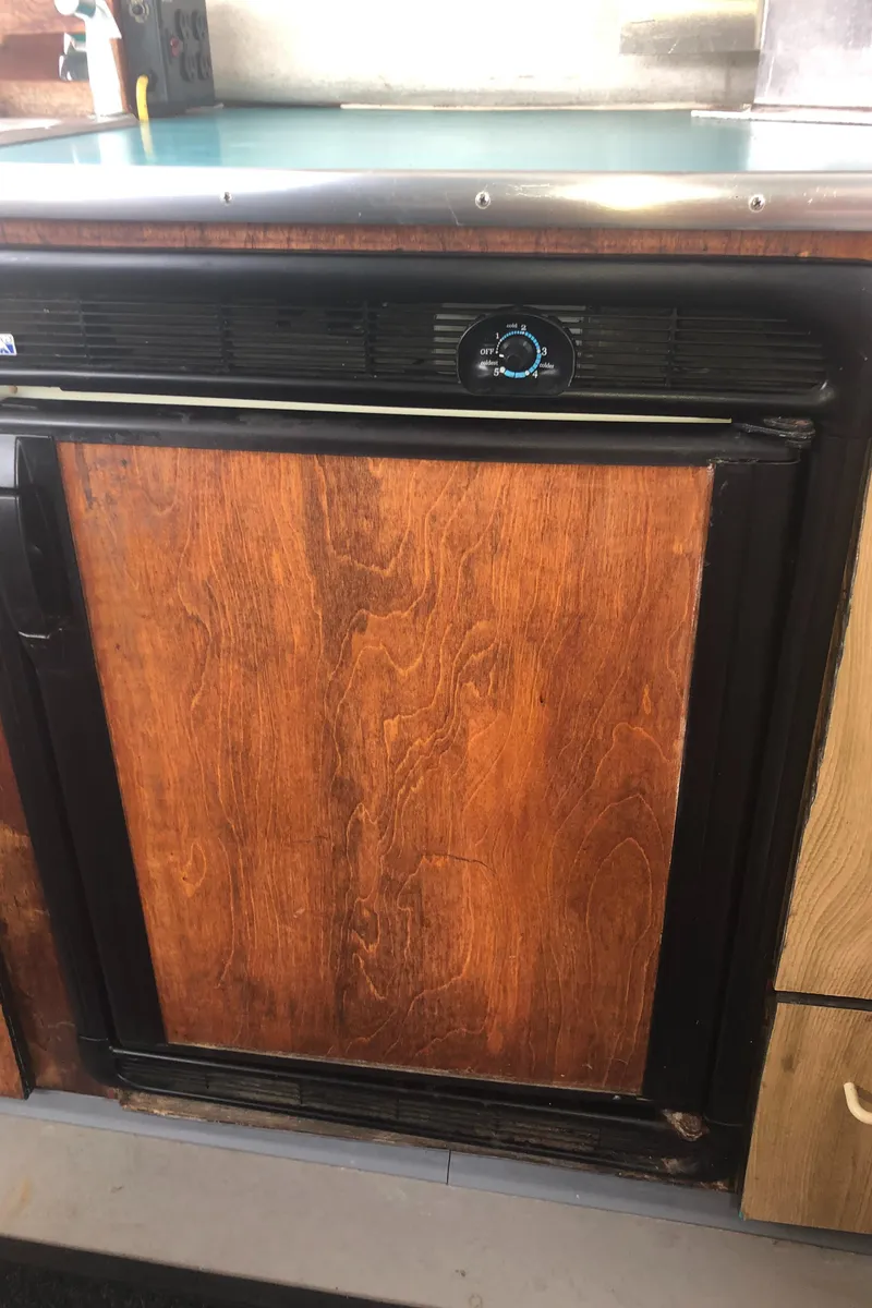 Slide: The Image of Wood-paneled refrigerator in a 1996 Martin Trunk Cabin kitchen. - 15