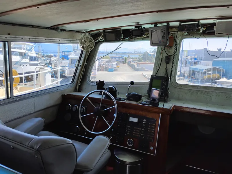 Slide: The Image of Interior of a 1996 Martin Trunk Cabin boat with steering wheel and navigation equipment. - 19