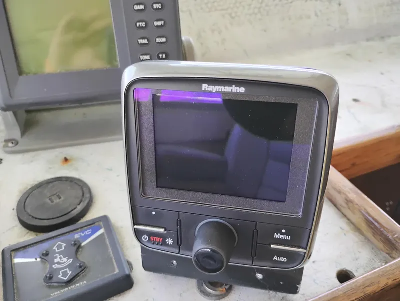 Slide: The Image of Raymarine navigation device on a 1996 Martin Trunk Cabin boat dashboard. - 22