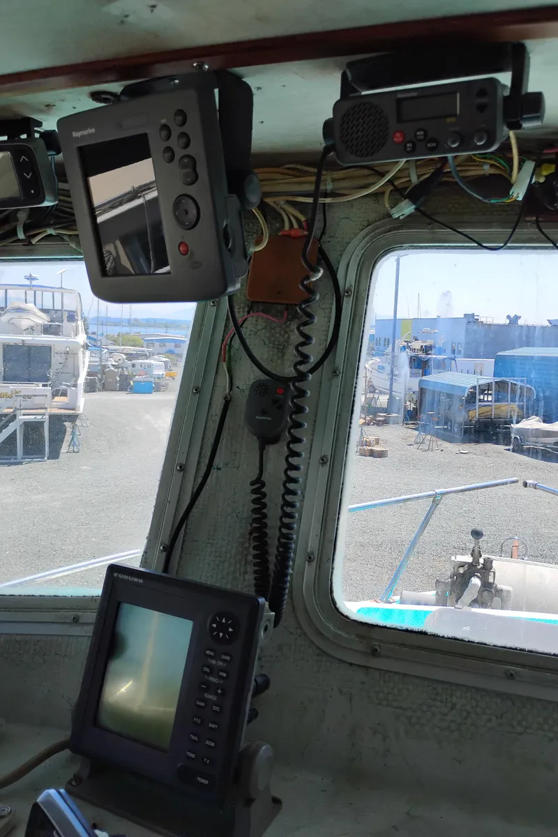 Slide: The Image of Interior of a 1996 Martin Trunk Cabin boat with navigation equipment and harbor view. - 25