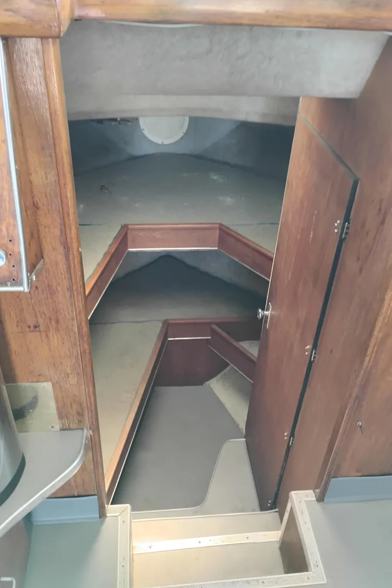 Slide: The Image of 1996 Martin Trunk Cabin interior with wooden finishes and compact sleeping area. - 26