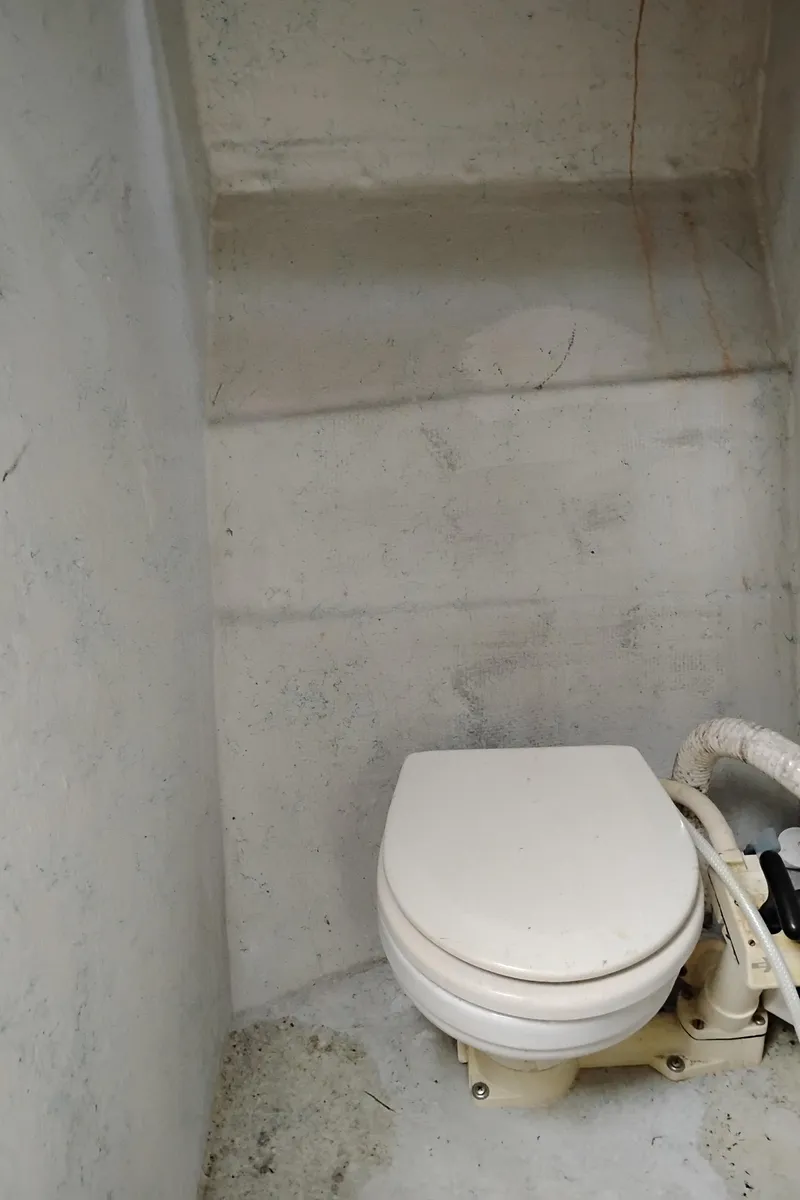 Slide: The Image of Compact marine toilet in a 1996 Martin Trunk Cabin boat. - 27