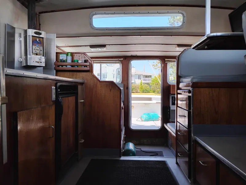 Slide: The Image of Interior of a 1996 Martin Trunk Cabin boat with wooden cabinetry and modern amenities. - 28