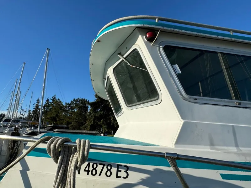 Slide: The Image of 1996 Martin Trunk Cabin boat docked, featuring windows and railing, with clear blue sky background. - 3