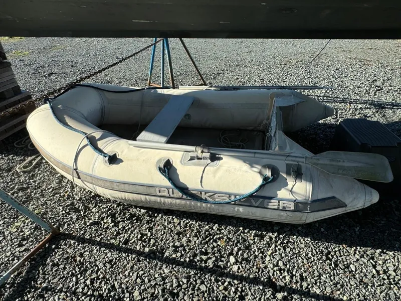 Slide: The Image of Inflatable dinghy on gravel, under a Martin Trunk Cabin, 1996 model. - 35