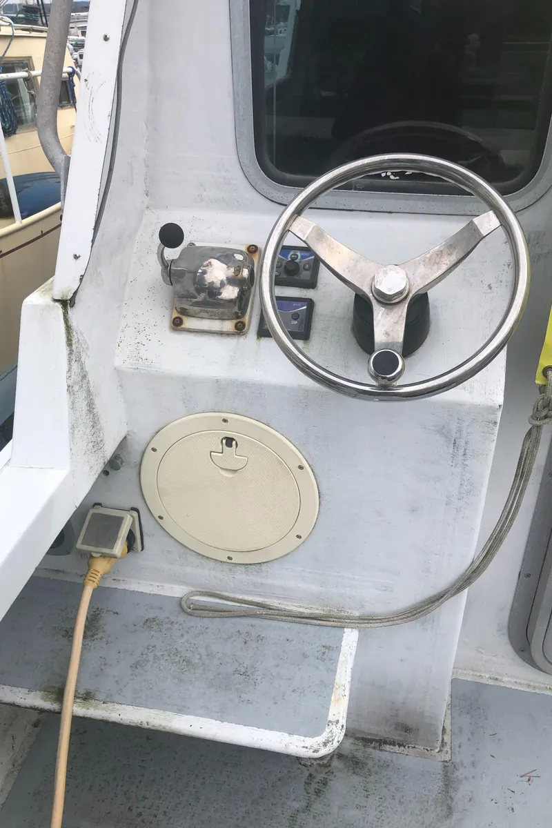 Slide: The Image of Steering wheel and controls of a 1996 Martin Trunk Cabin boat. - 8