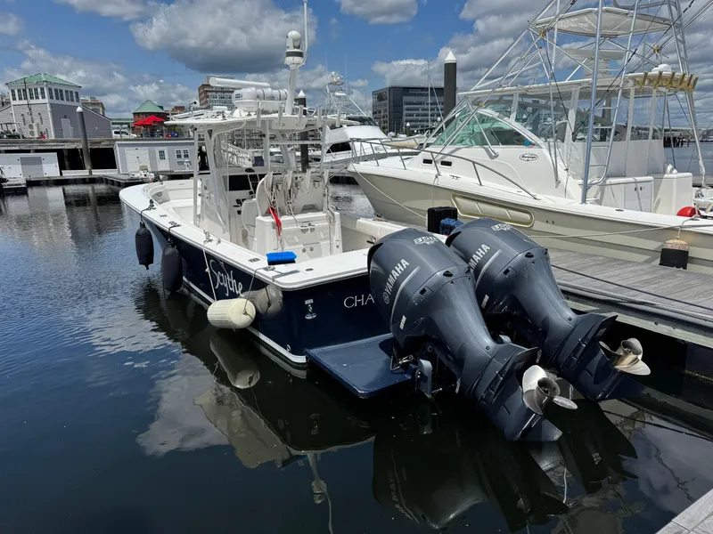 Slide: The Image of 2014 Regulator 34 Center Console boat docked with twin Yamaha engines. - 6