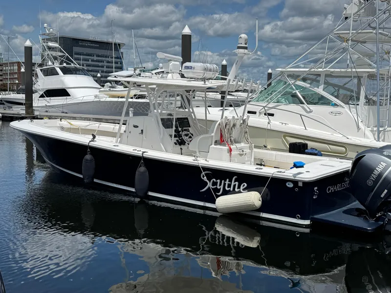 Slide: The Image of 2014 Regulator 34 Center Console boat docked in marina, clear sky, calm water. - 7