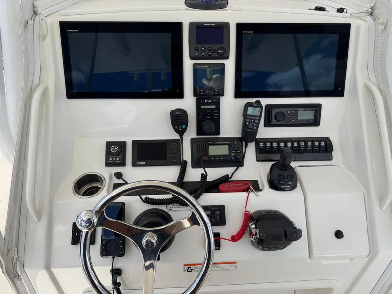 Slide: The Image of 2014 Regulator 34 Center Console helm with dual screens and navigation controls. - 8