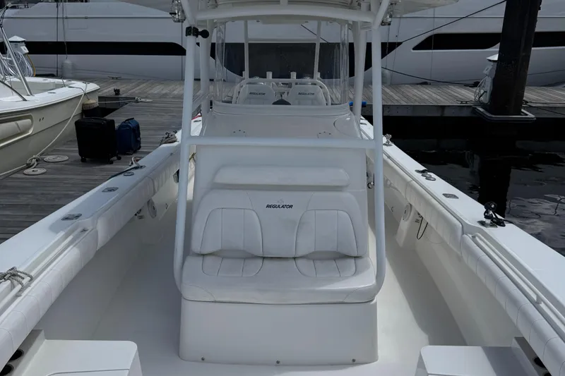 Slide: The Image of 2014 Regulator 34 Center Console boat docked at marina. - 9