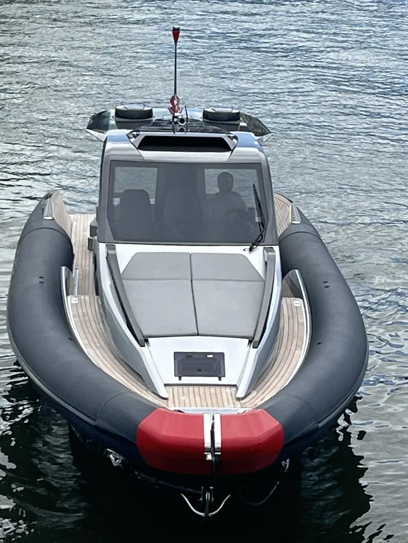 Slide: The Image of 2022 Anvera 42 boat on water, sleek design, black and red accents, modern cabin. - 2