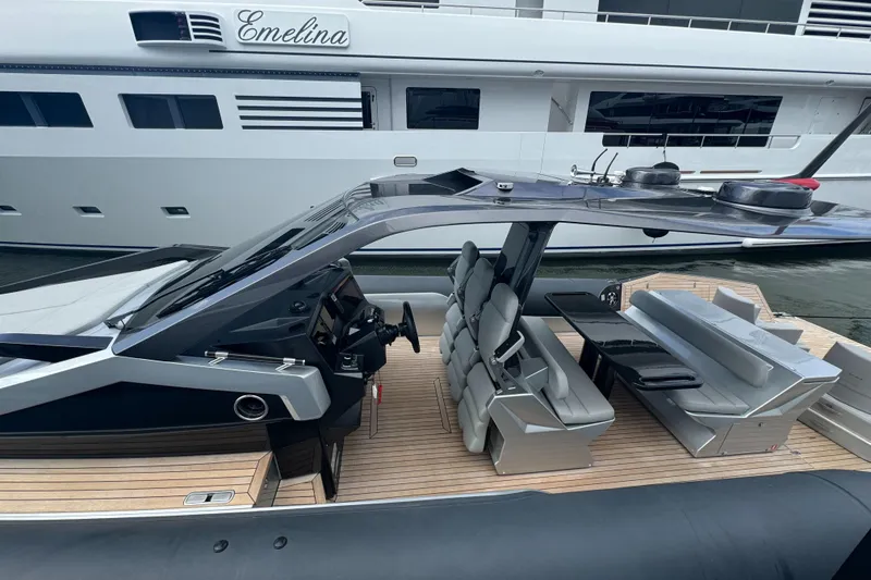 Slide: The Image of 2022 Anvera 42 luxury boat with sleek design and modern seating, docked beside a larger yacht. - 3