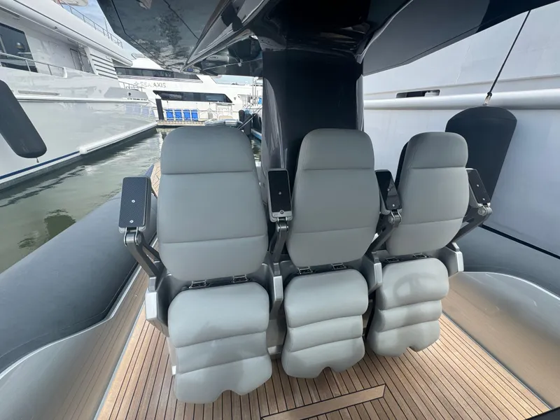 Slide: The Image of Three sleek seats on a 2022 Anvera 42 boat, docked at a marina. - 5