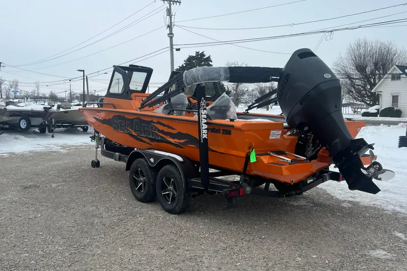 Slide: The Image of 2026 SeaArk ProCat 200 boat in vibrant orange, parked on a snowy lot. - 12