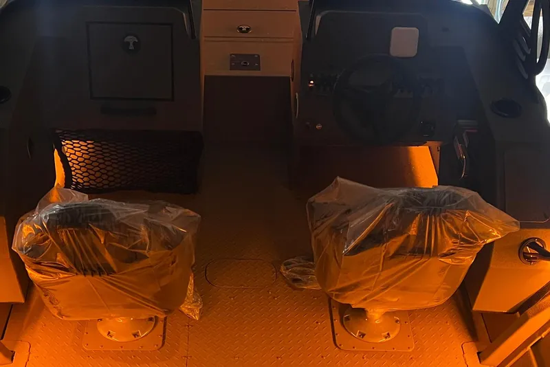 Slide: The Image of 2025 SeaArk ProCat 200 boat with vibrant orange design and mounted equipment. - 5